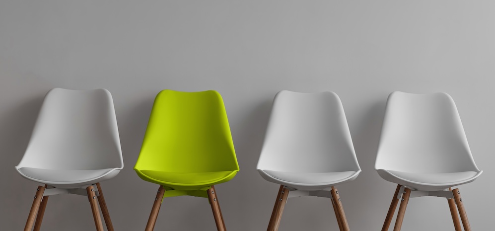 Three vacant white chairs and yellow on gray wall background in office or living room. Job opportunity, business, recruiting due covid-19 concept, free space. concept of lack of good candidates.