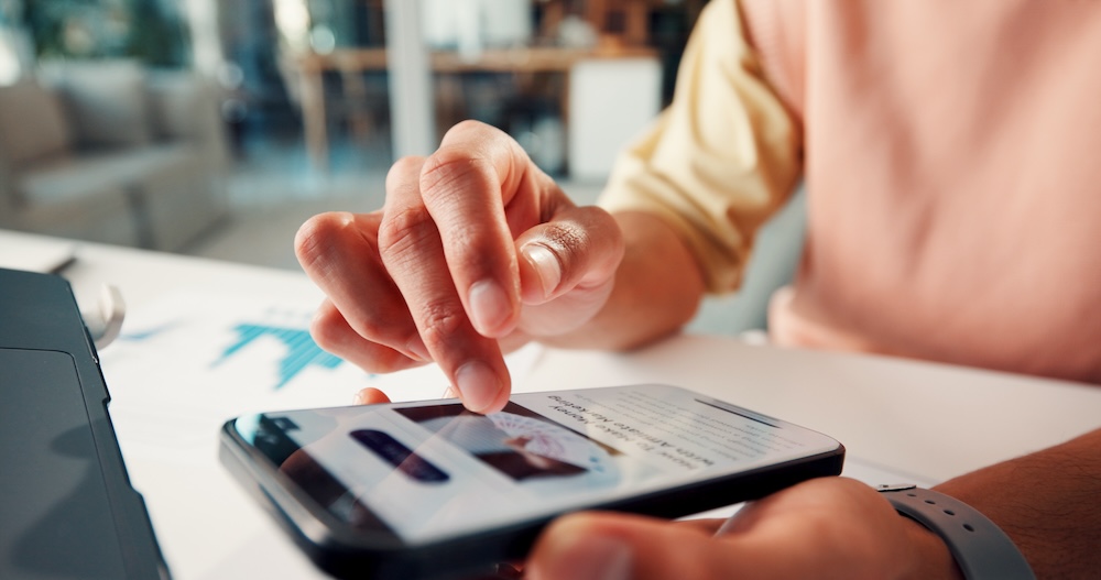 Person browsing a mobile-friendly business website on a smartphone, highlighting modern web design, mobile optimization, user experience, and responsive website performance for businesses.