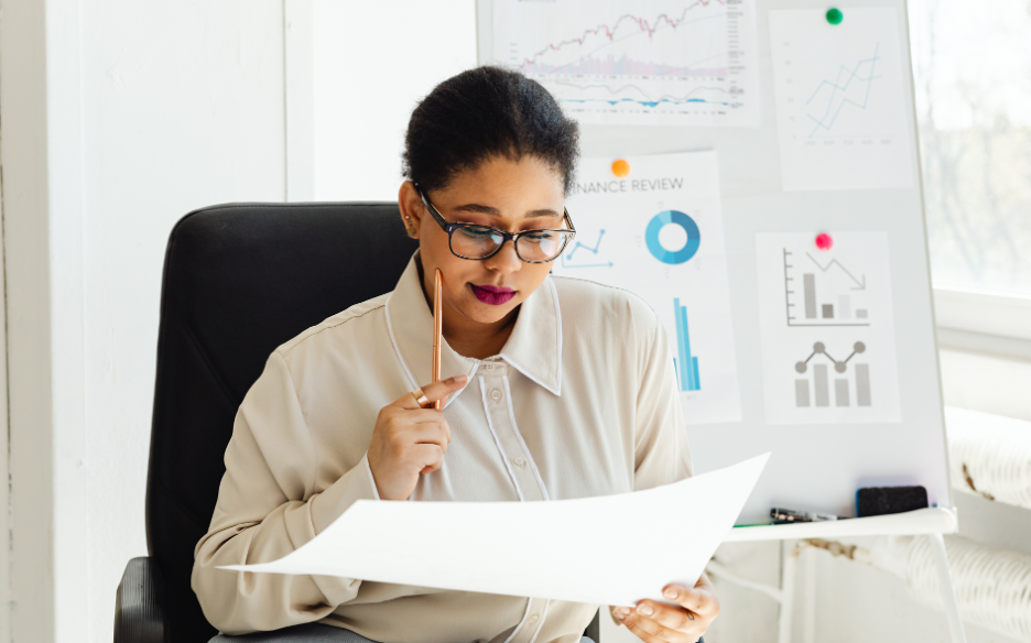 Sales professional reviewing business data and analytics reports to identify trends and performance insights